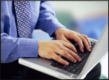 Man typing at laptop PC